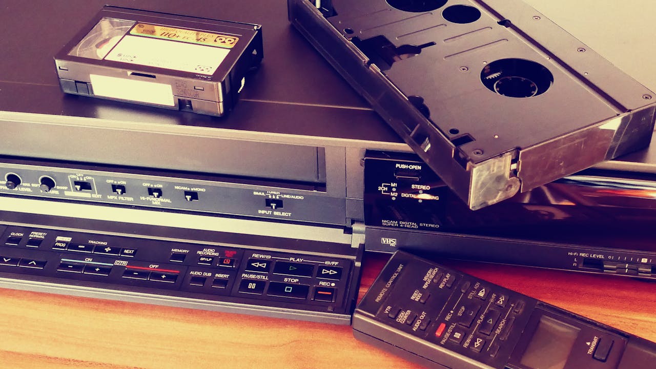 Vintage VHS player with cassette and remote control, representing classic tech nostalgia.